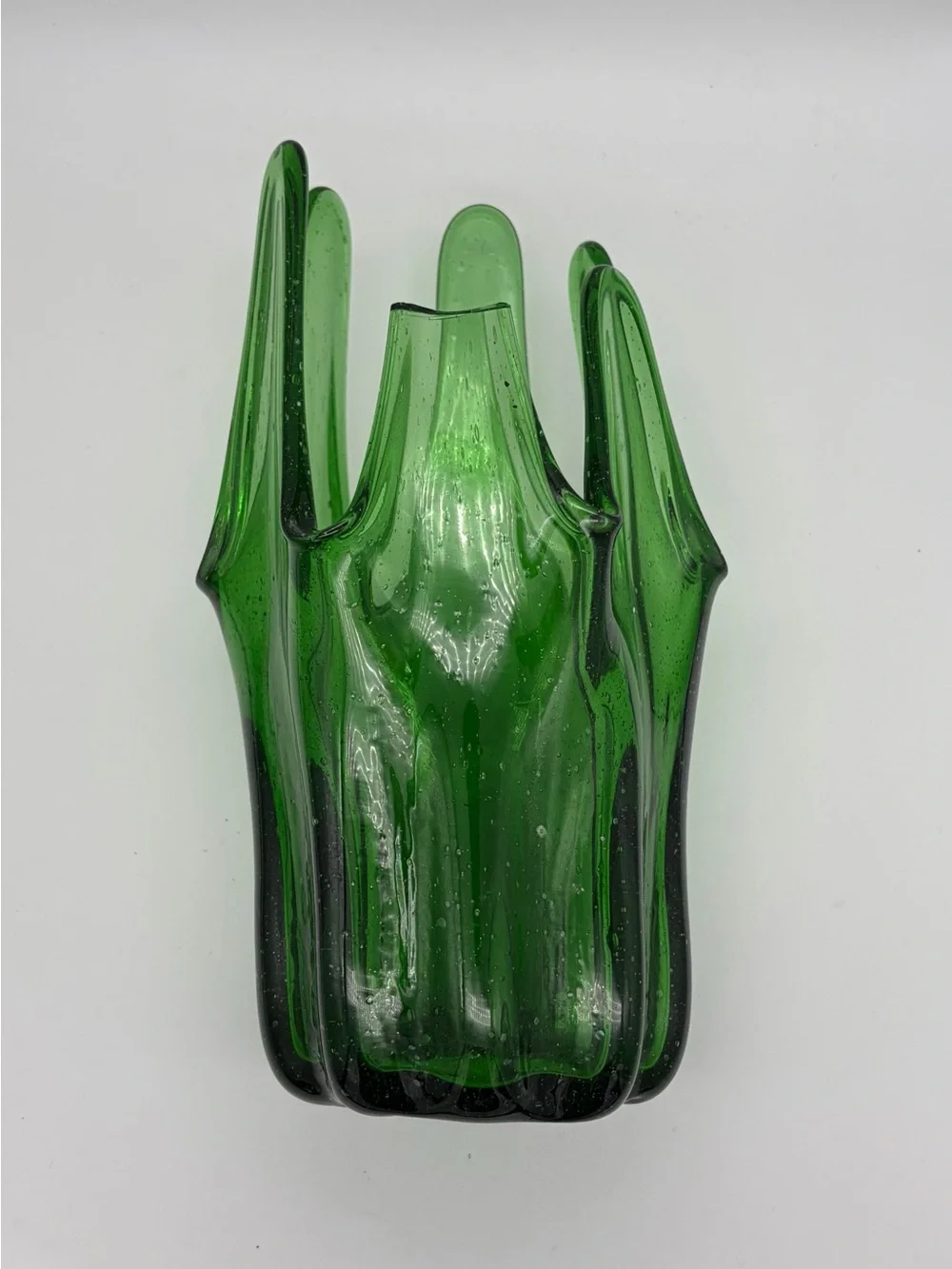 Vintage green swing glass vase with purple lily trumpet flowers.